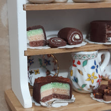 Load image into Gallery viewer, Dresser with Chocolate Cakes.
